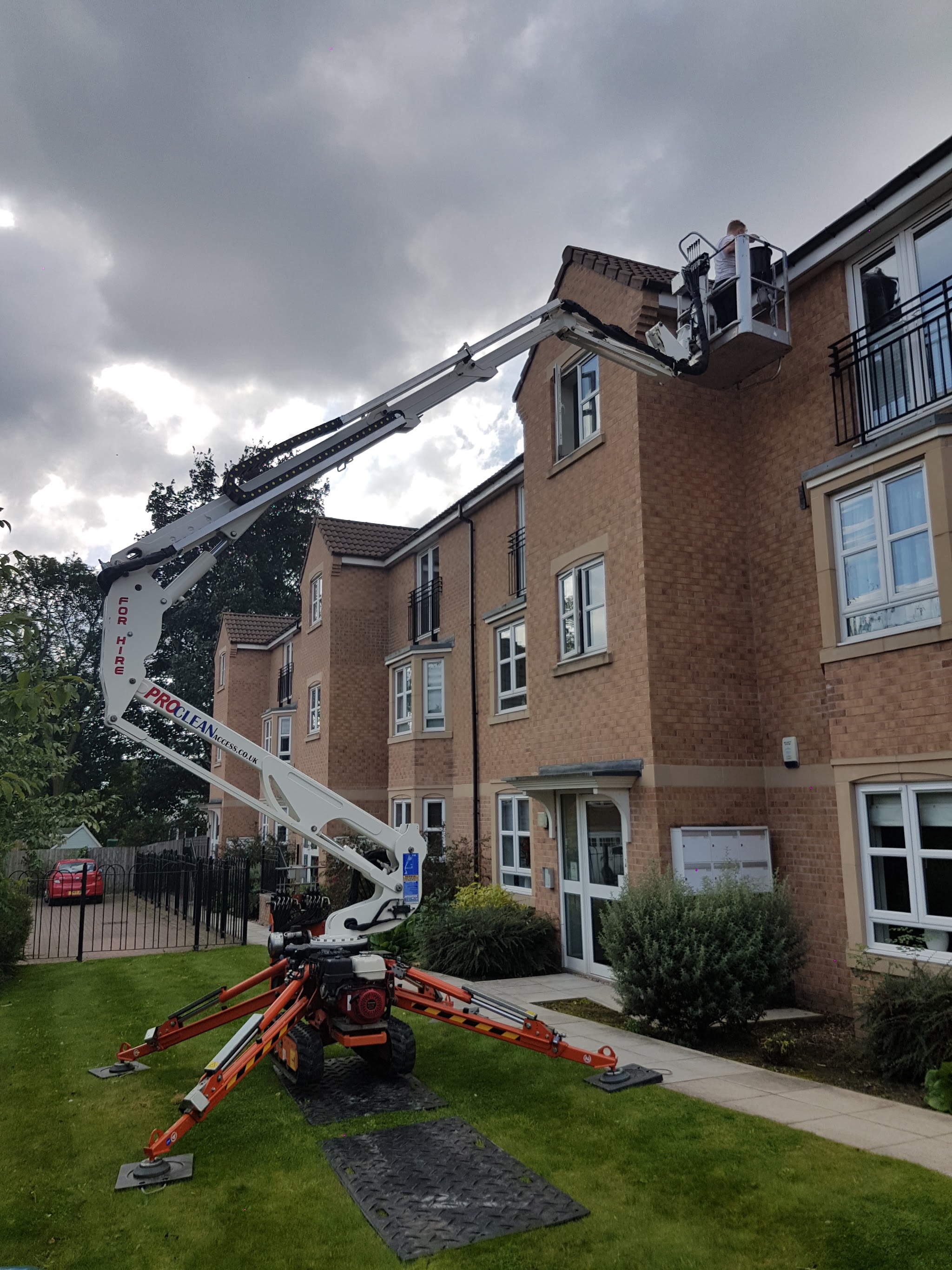 Branded ProClean Access tracked platform extended beside a building